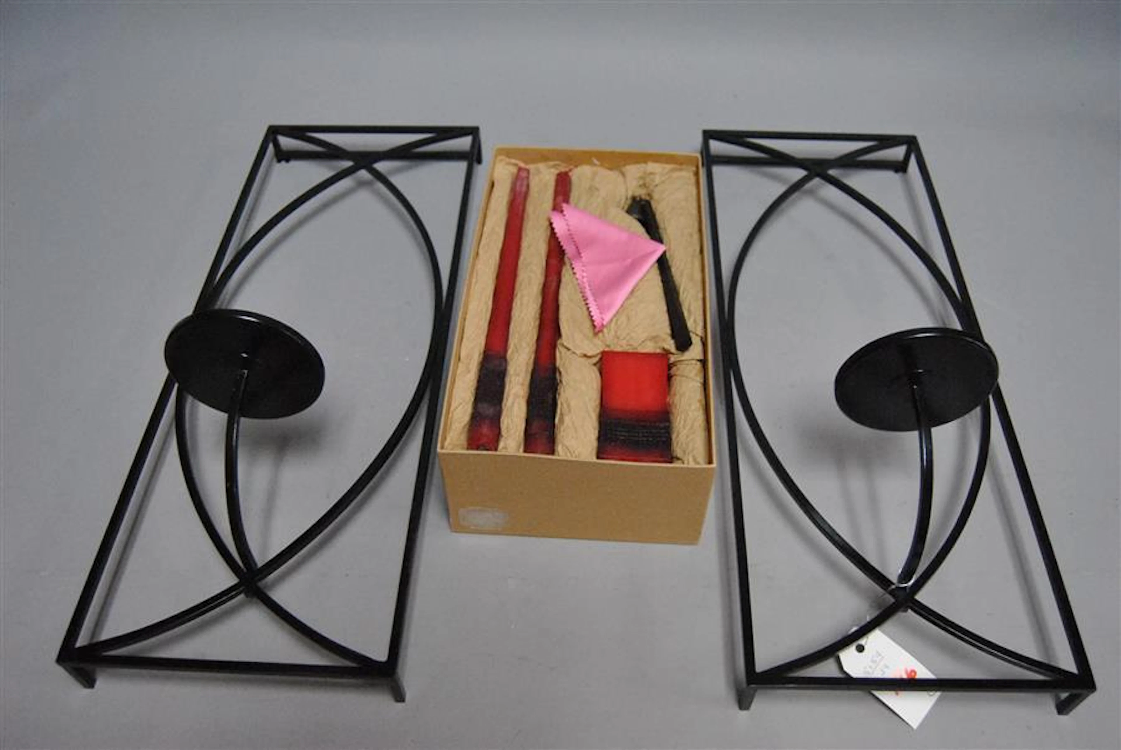 Pair of metal wall mounted candle sconces and candles made by John Hardy