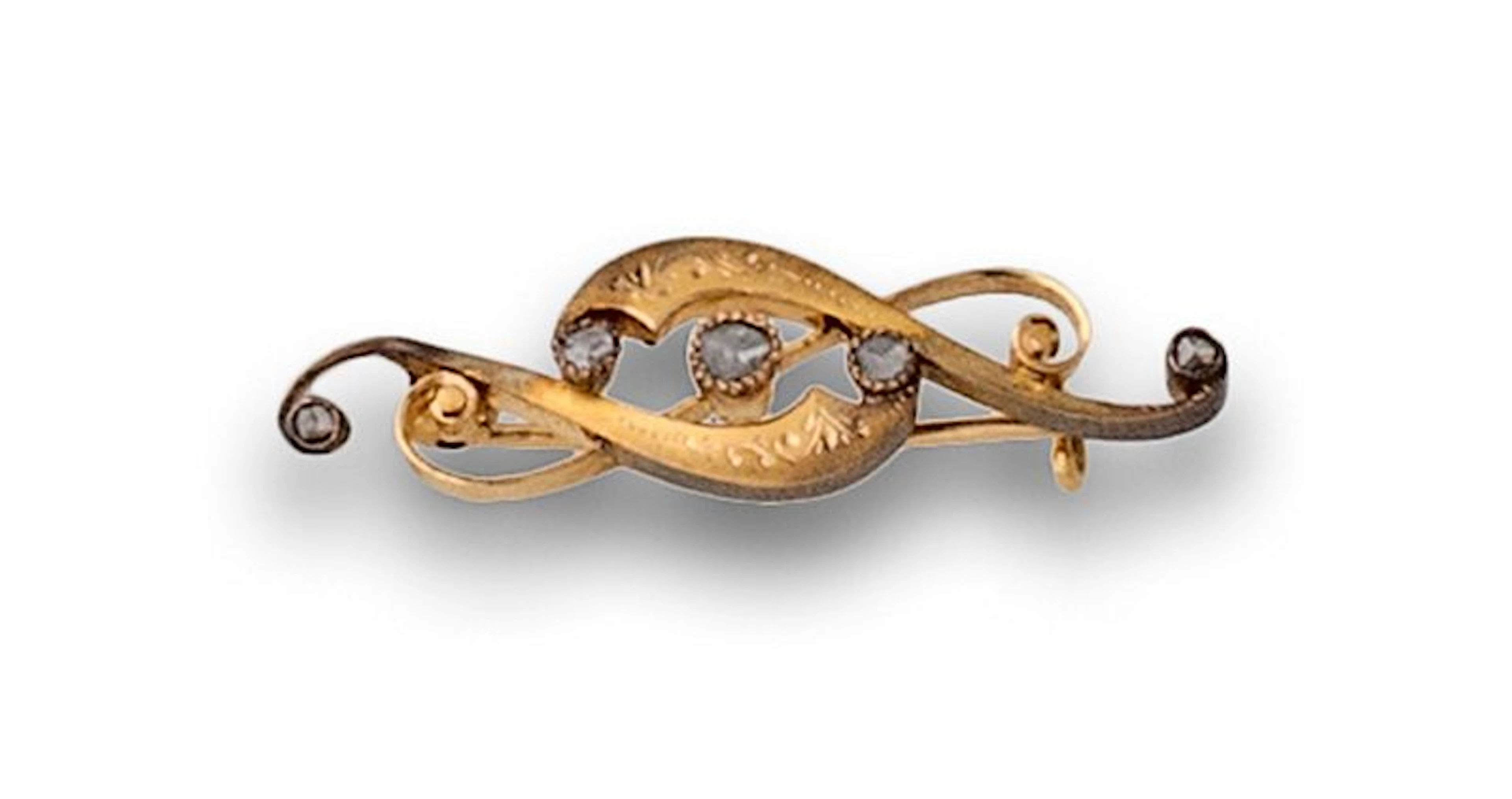 Broches XIX a modo de clave de sol de 18K oro y diamantes.