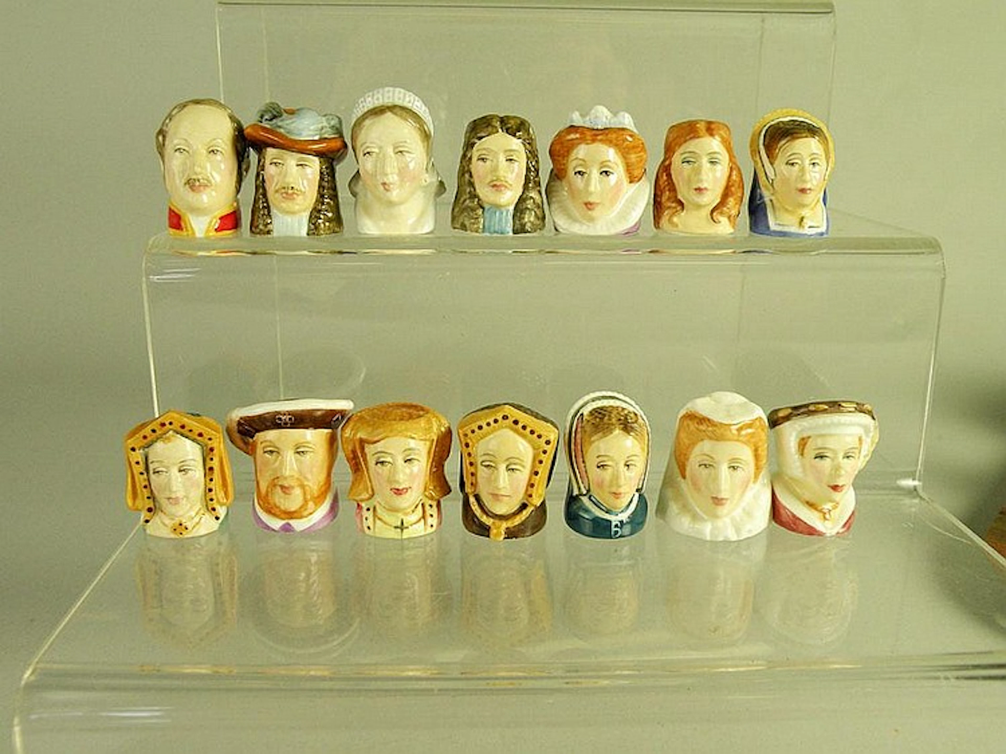 A collection of Staffordshire character thimbles,