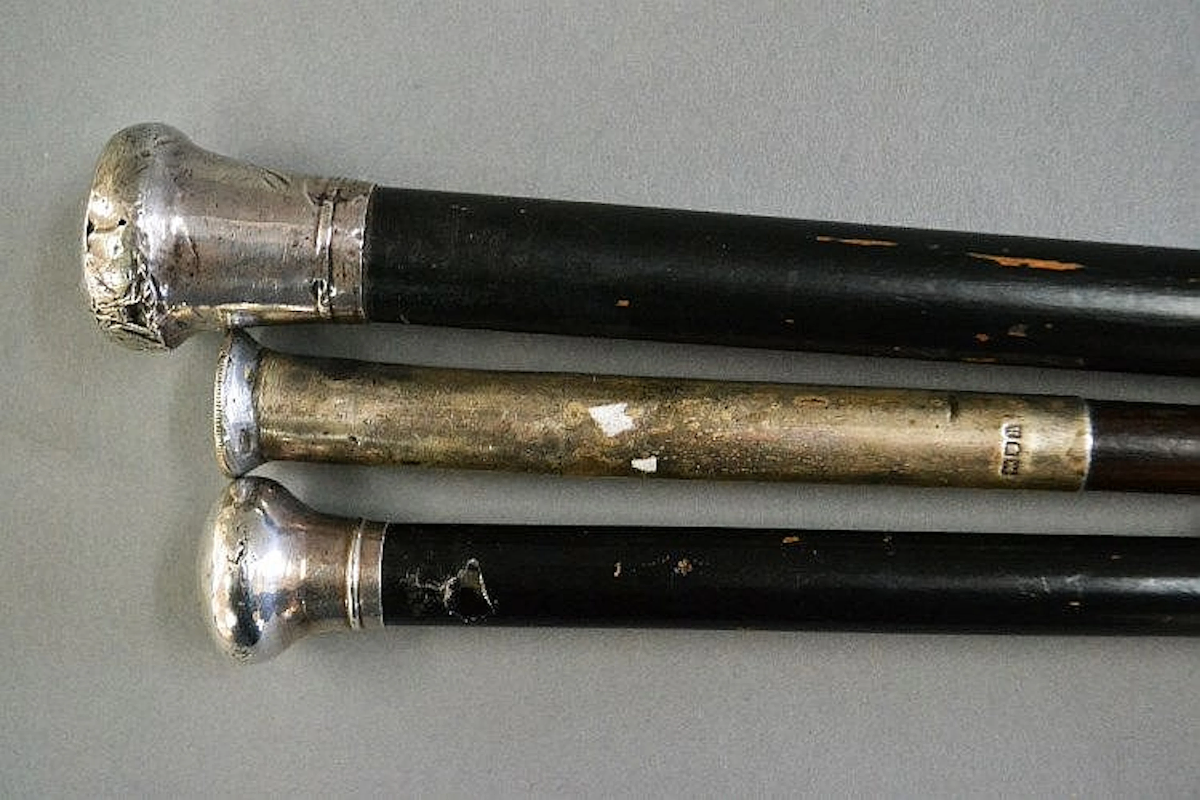 Three English sterling silver topped canes, one