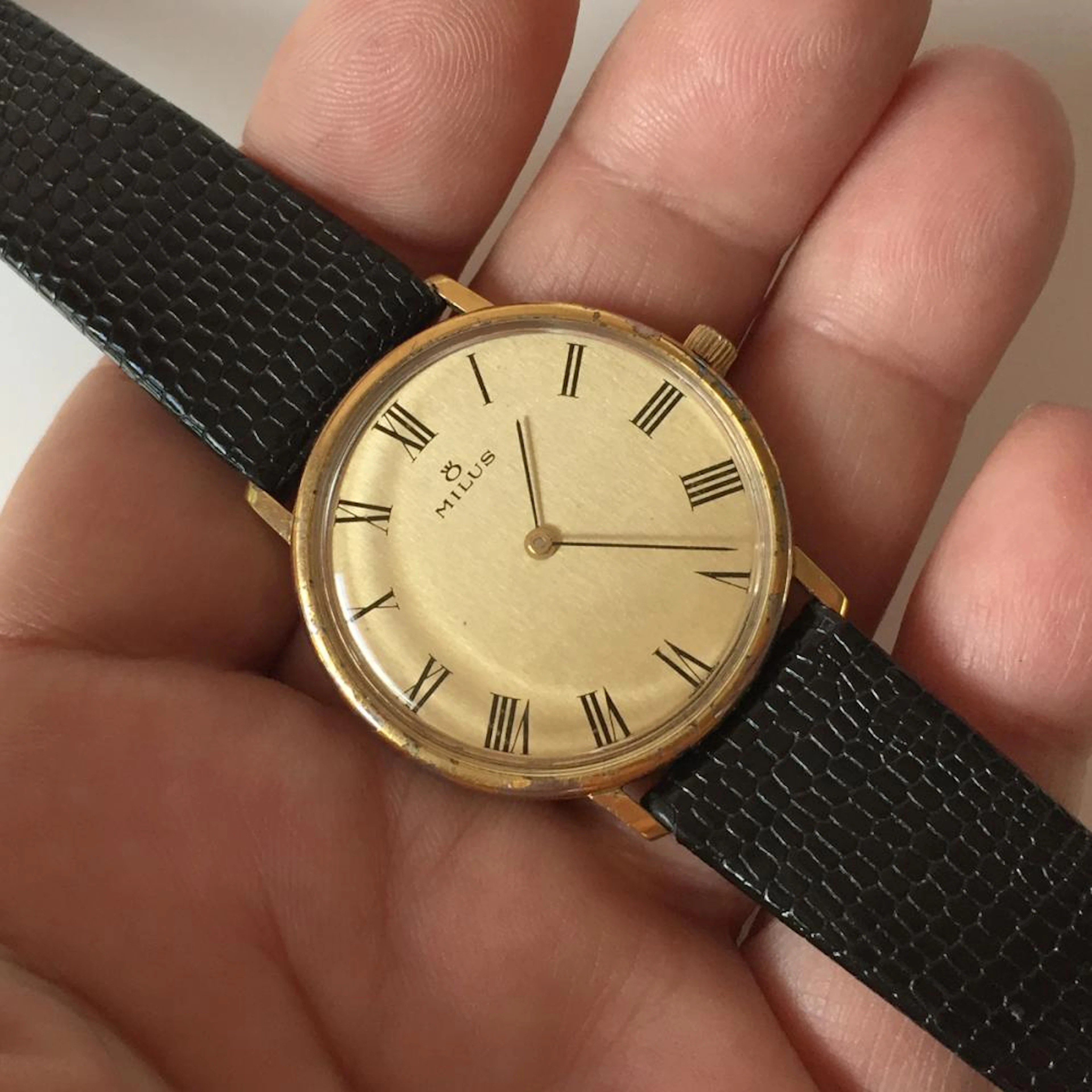 Vintage gold color MILUS Swiss made round watch with black genuine leather strap