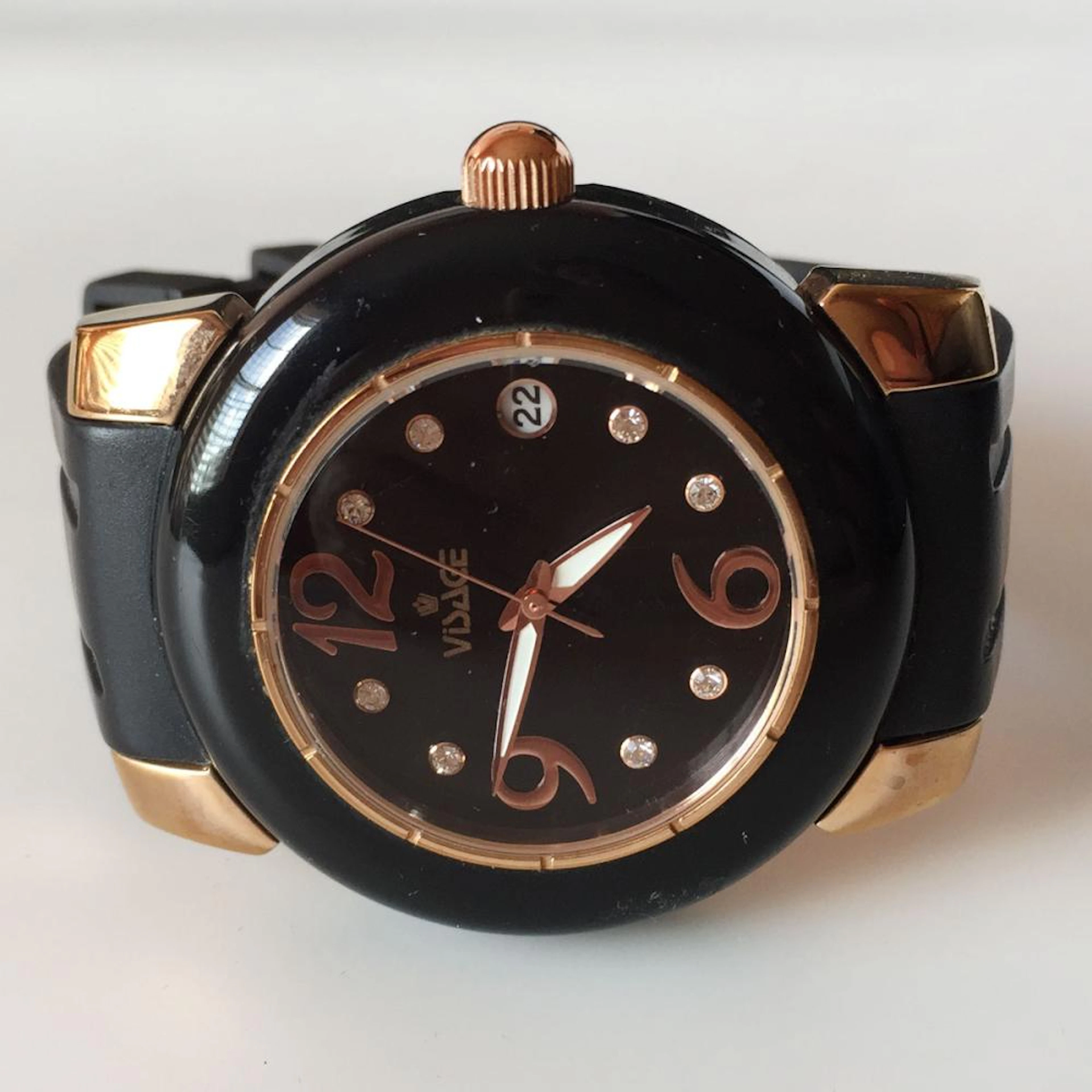 VISAGE: Rose tone stainless steel watch with black dial, rubber band and bezel