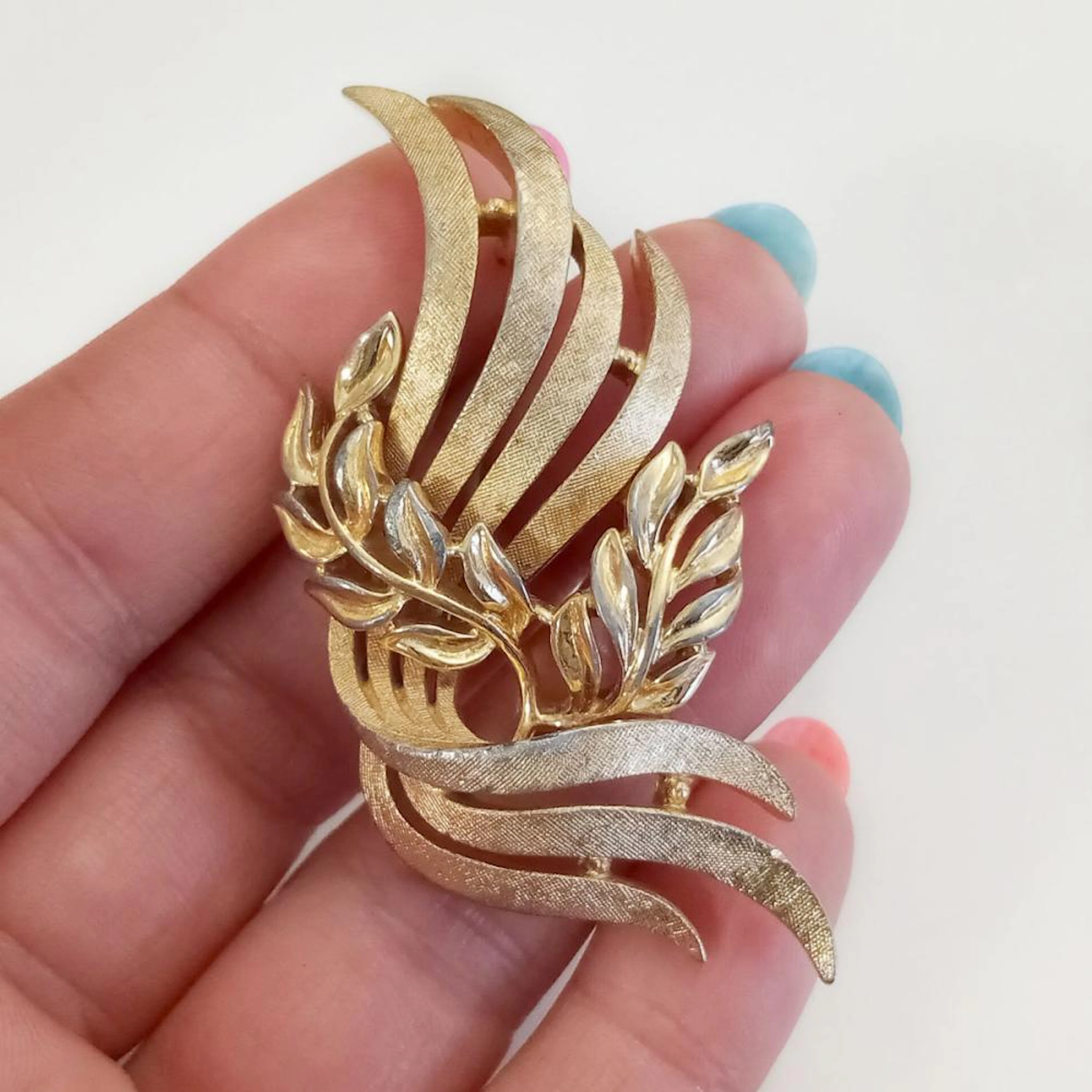 TRIFARI: Vintage gold tone textured and shiny finish Leaves Waves shape brooch