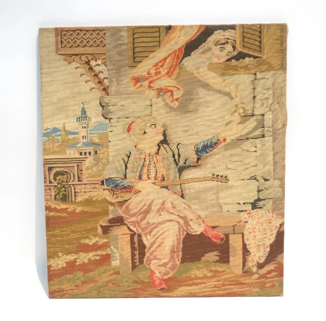 Antique needlepoint of man playing mandolin