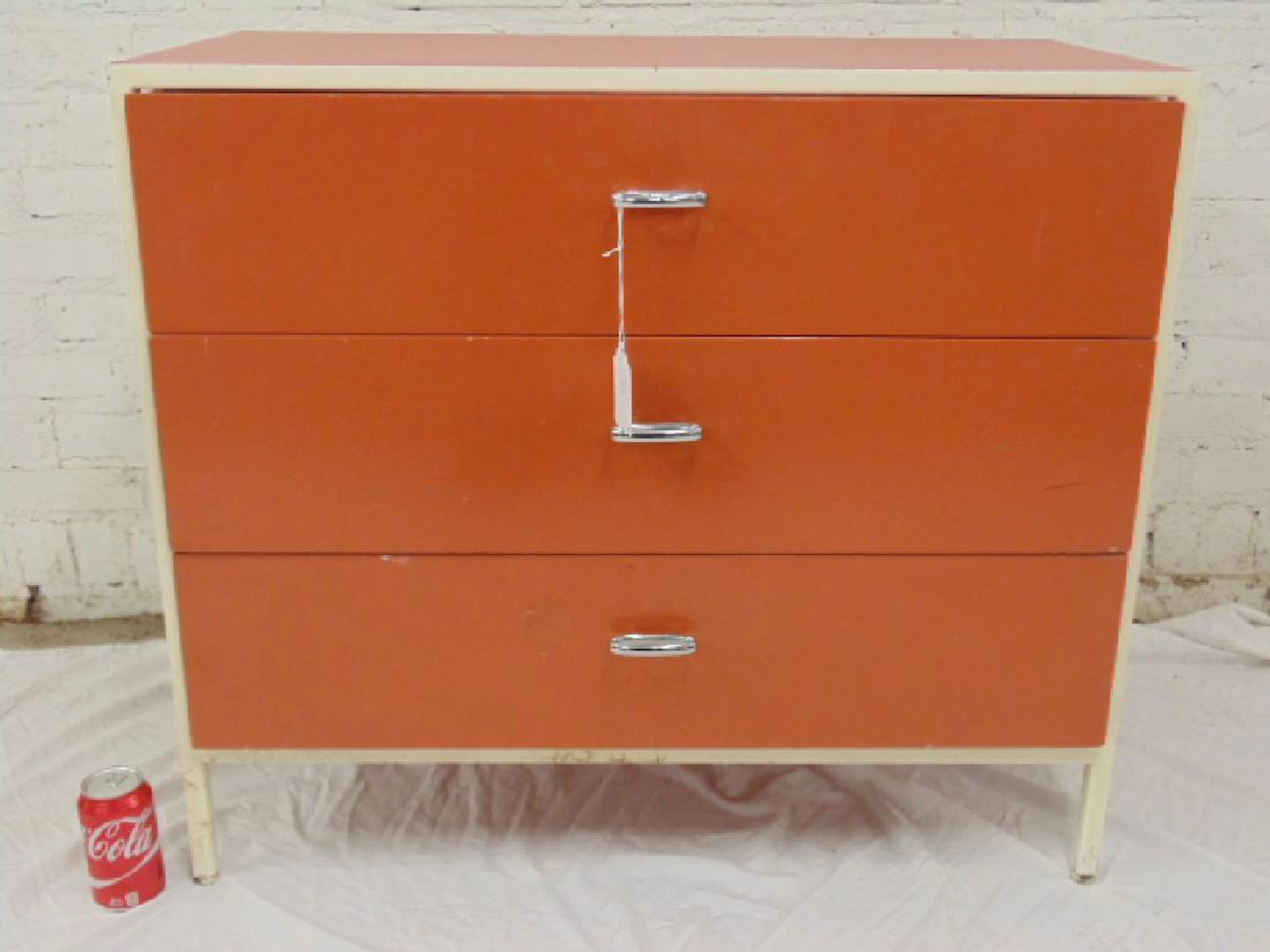 Herman Miller chest, orange in white frame
