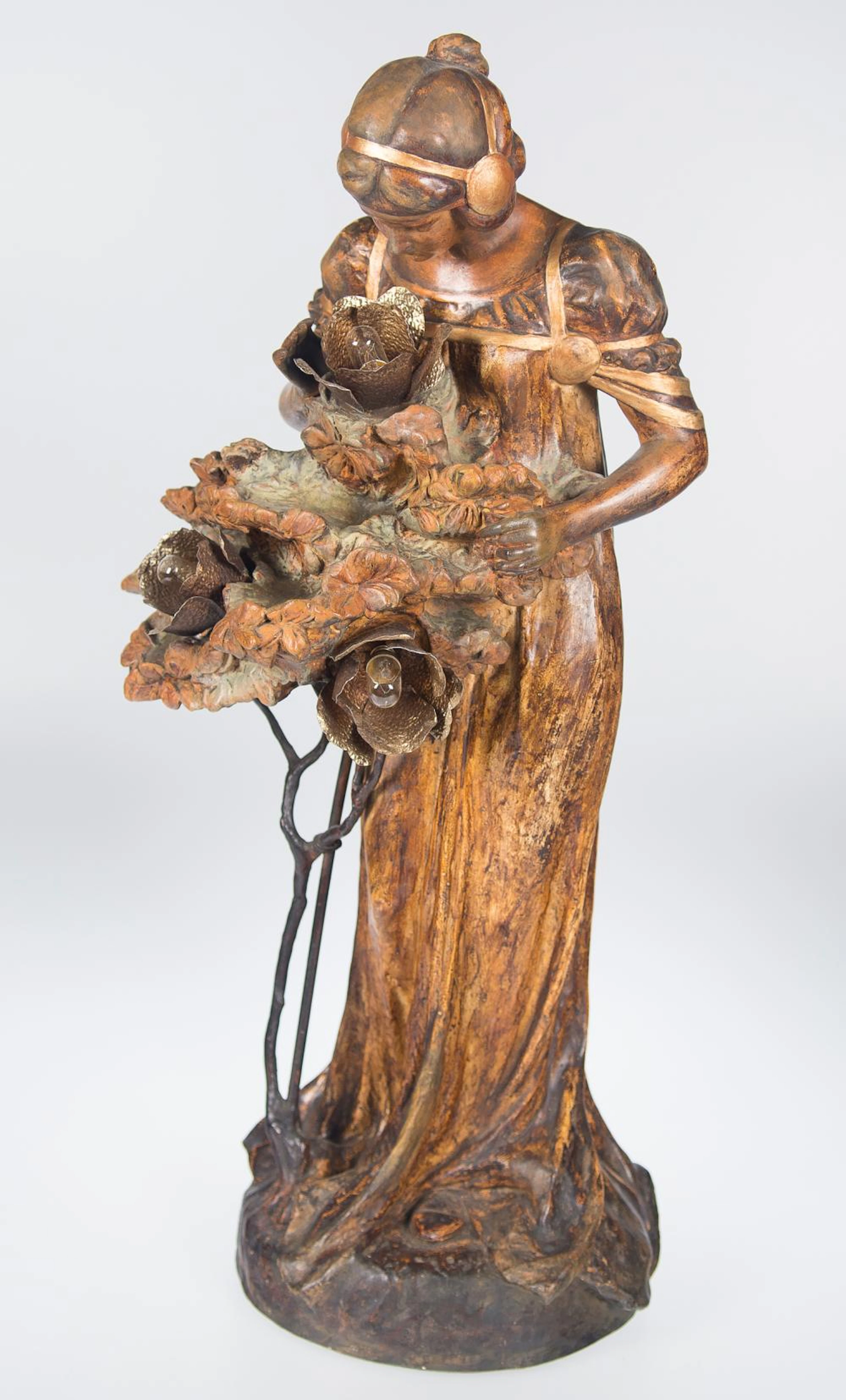 Patinated and gilded stucco lamp sculpture. Art Nouveau. Circa 1900.